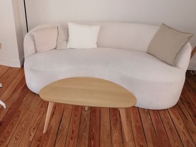 an image of a living room with a white couch and a coffee table