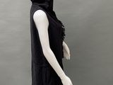 the mannequin is wearing a black hoodedie with fringes on it