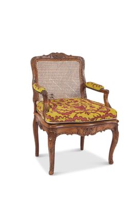 an image of a wooden chair with a yellow and red patterned seat