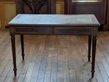 a small table with a marble top in a room