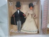 two dolls that are in a box on a table