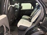 the interior of a car with two rows of seats and a door open