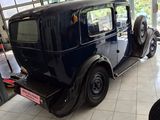 an old car in a showroom with a lot of windows