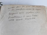 an old book with writing on it sitting on a table