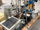 many machines that are sitting on a pallet in a warehouse