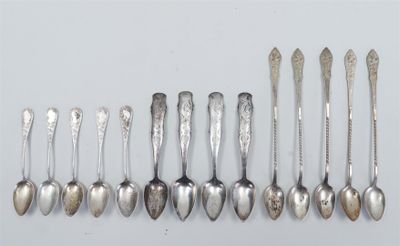 several spoons and spoon spoons are lined up on a white surface
