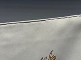 a close up of a white bag with a logo on it