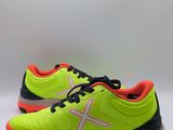 a pair of yellow and black tennis shoes on a white background