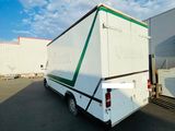 a white truck with a green stripe parked in a parking lot