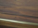 a close up of a wooden table with a clock on it