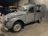 a small grey truck parked in a garage
