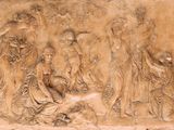 a relief of a group of people on a wall