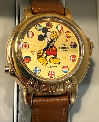 mickey mouse watch in a box with a brown leather strap