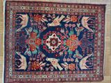 an image of a rug with animals and flowers on a wooden floor