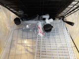 a cat in a cage that is sitting on the floor