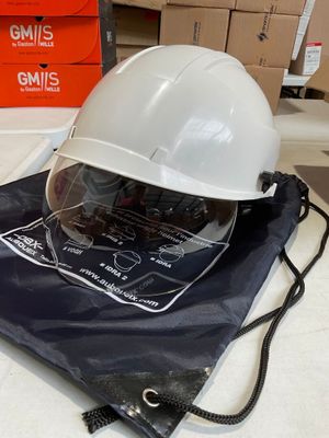 a white hard hat sitting on top of a blue bag