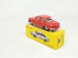 a red toy car sitting on top of a yellow box