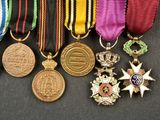 several medals and medals are displayed on a black surface