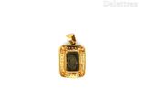 an image of a gold pendant with a picture of a man