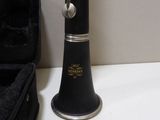 a clarinet that is sitting on a table next to a case