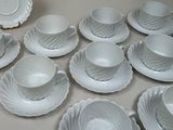 a lot of cups and saucers on the table