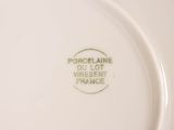 a close up of a white plate with green writing on it
