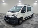 the white van is parked in a large room with checkered floor