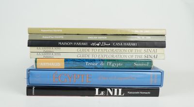 several books are stacked on top of each other on a white surface
