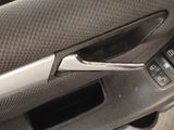 a close up of a car door handle with a remote control