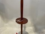 a lamp that is on a wooden stand