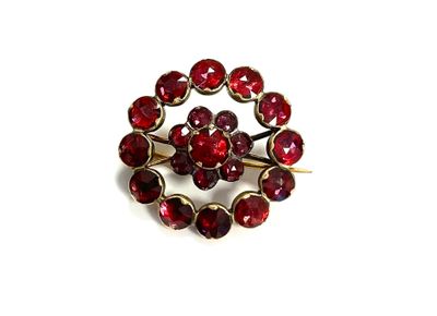 an image of a close up of a red broochle on a white surface