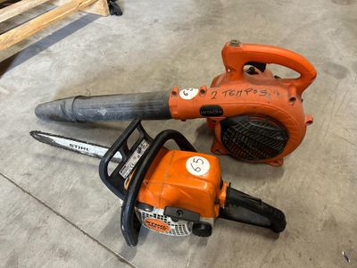 a chainsaw and a blower sitting on the floor