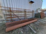 a pile of rusted pipes outside of a building