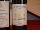 two bottles of wine sitting next to each other on a table