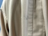 a close up of a shirt that has a button on it