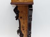 an image of a wooden shelf with carvings on it