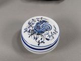 a small blue and white box with a bird on it