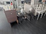 many chairs and tables in a room with black wood floors