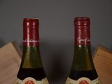 two bottles of wine sitting next to each other on a table