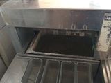 a small oven with a lot of cooking utensils inside of it
