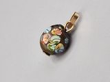 une photo d'un pendentif orné d'un motif floral