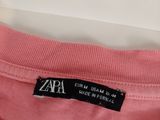 a pink shirt with a label on it that says zara
