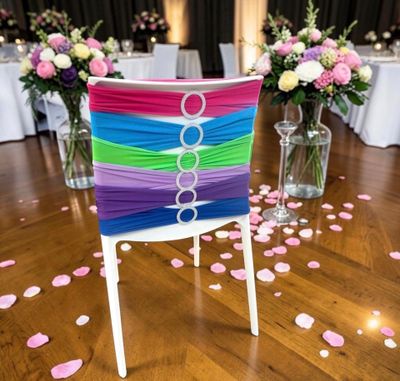 a chair with a colorful sash on it in front of a vase of flowers