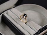 a black and white diamond ring in a black case