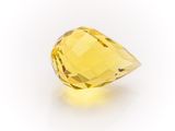 a close up of a yellow diamond on a white background