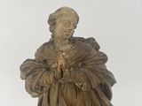 statue of a woman holding a flower in her right hand