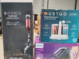 two boxes of vacuum cleaners sitting on a table in a warehouse