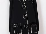 a black sweater with white stitching and buttons on the front