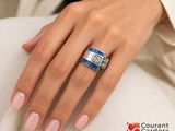 woman ' s hand with a blue and white ring on it ' s finger