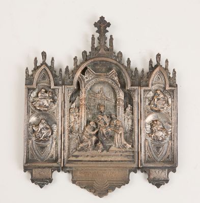a metal sculpture of a religious scene on a wall